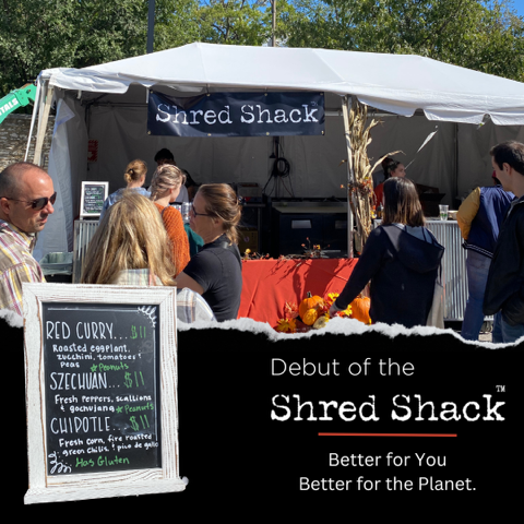 Food tent at an outdoor market with people waiting in line to buy Harvest Shreds from the Shred Shack. Three options available as noted on framed sign: Red Curry, Szechuan, Chipotle. Photo taken at the St. Louis Botanical Gardens Annual Best of Missouri Market, 2023.